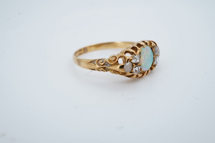 A late Victorian 18ct gold and oval white opal ring with six stone diamond set shoulders, size J, hallmarked for Birmingham, 1899, gross weight 2.5 grams. Condition - poor to fair